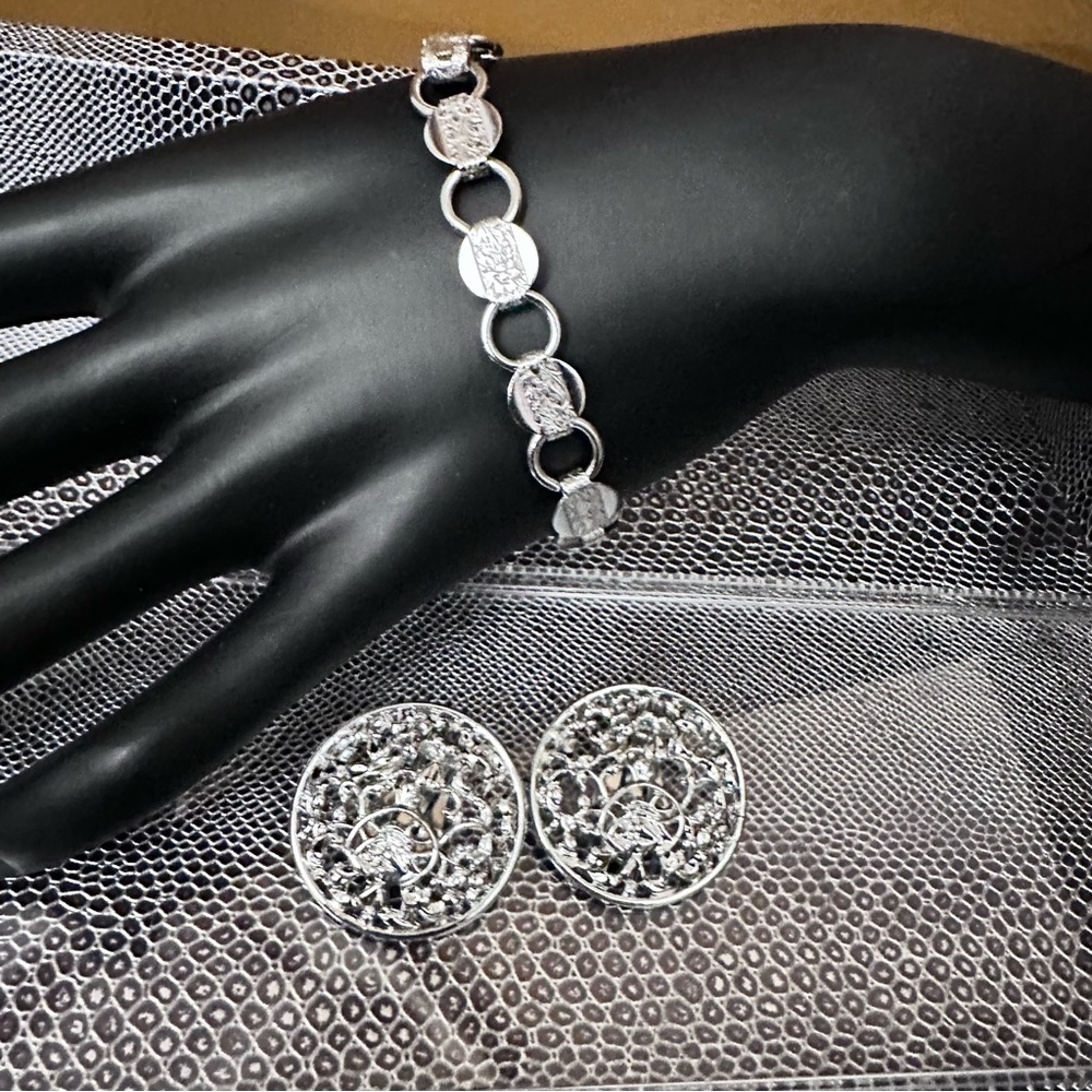 Sarah Coventry silver tone clip earrings and bracelet lot.